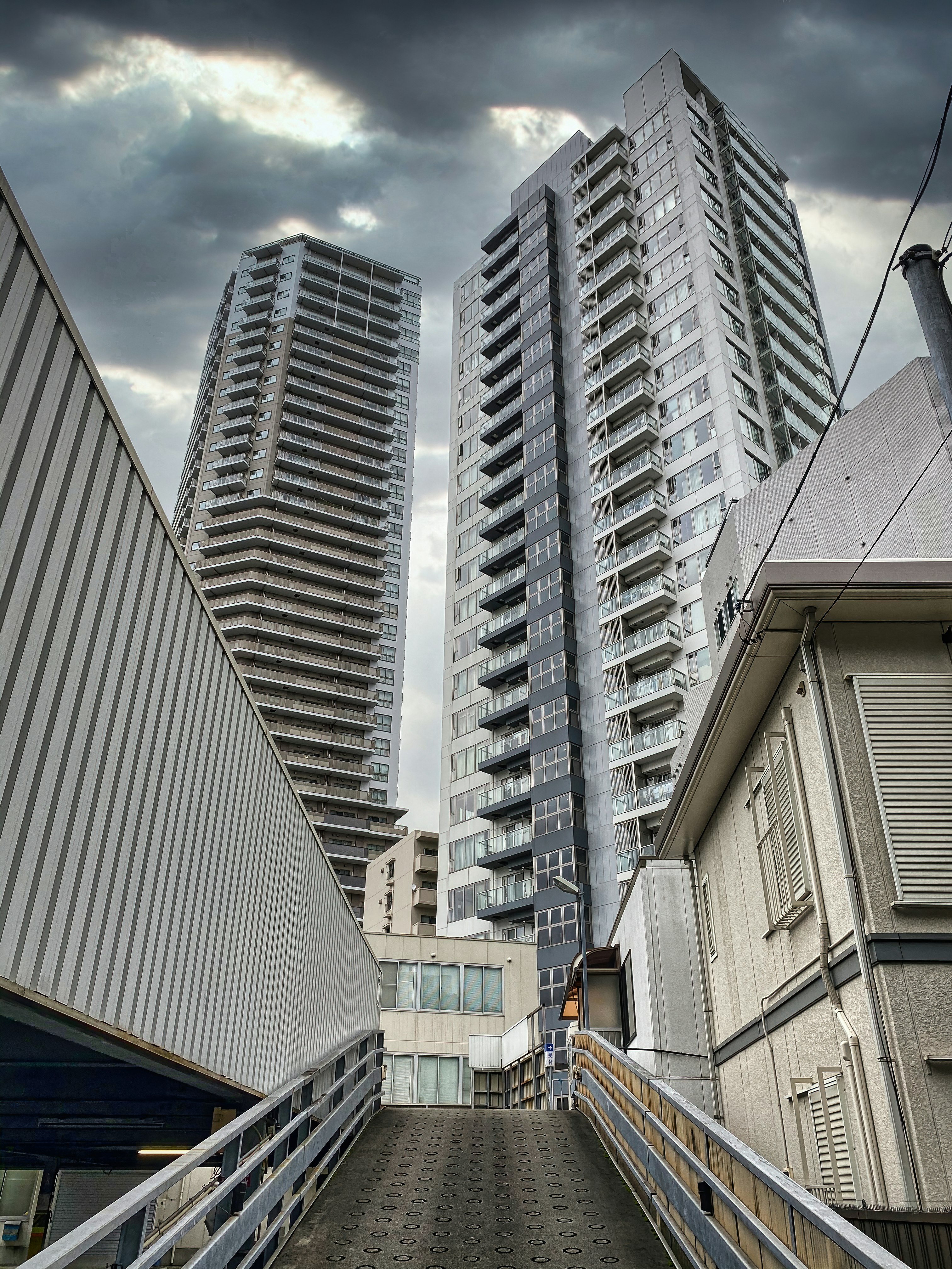 white and gray concrete building under white clouds during daytime